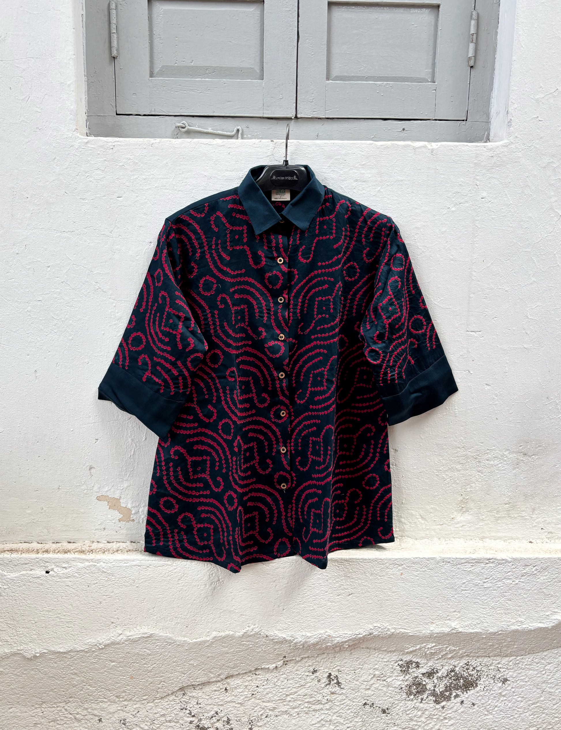 Midnight Blue hand tie-dyed Bandhani cotton shirt with vibrant Magenta motifs, classic shirt collar and relaxed fit from the Jhankar collection.
