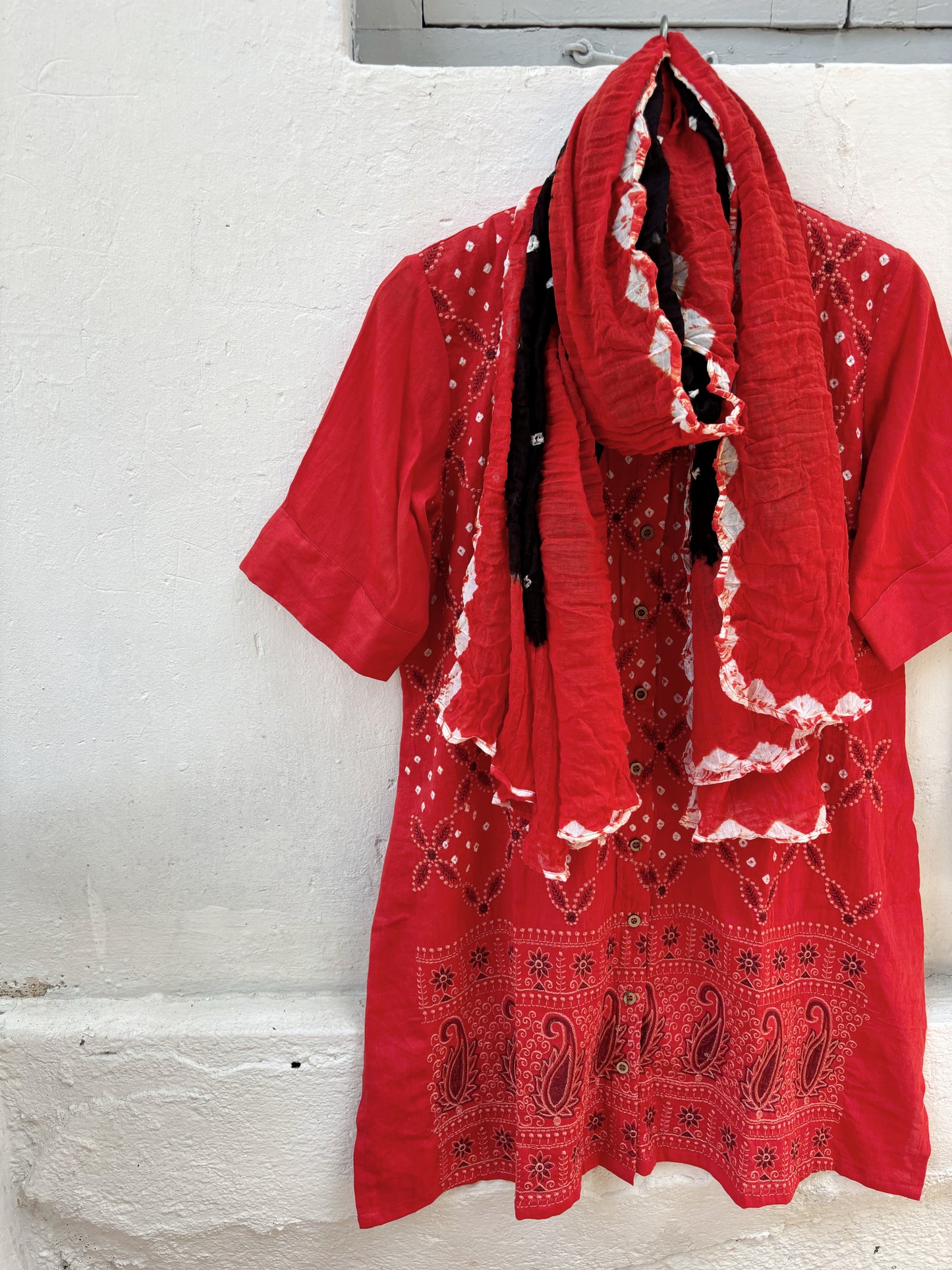 Orange and black Bandhani three-piece set for women with embroidered kurta, comfortable-fit pants and hand tie dyed dupatta