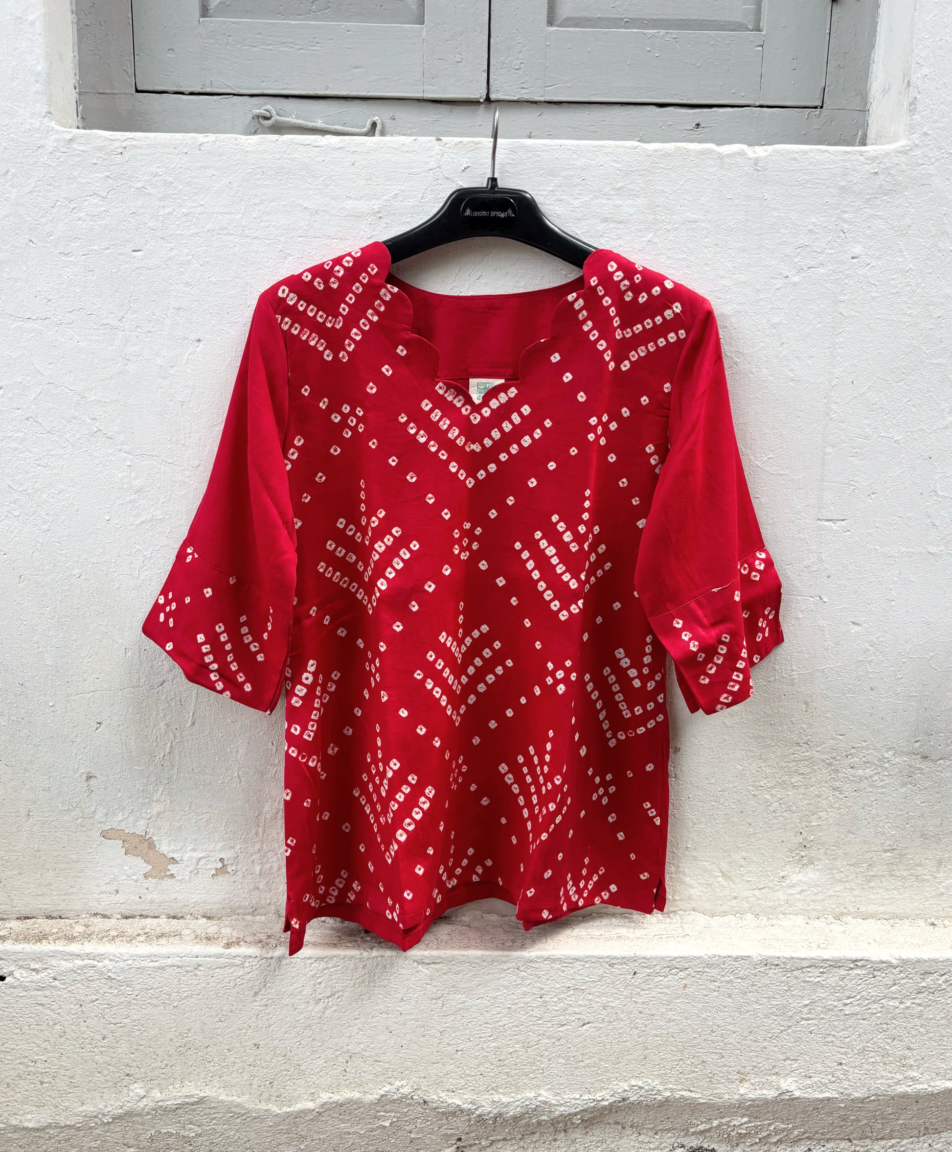 Relaxed fit sindoor red cotton satin Bandhani top with elbow-length sleeves.