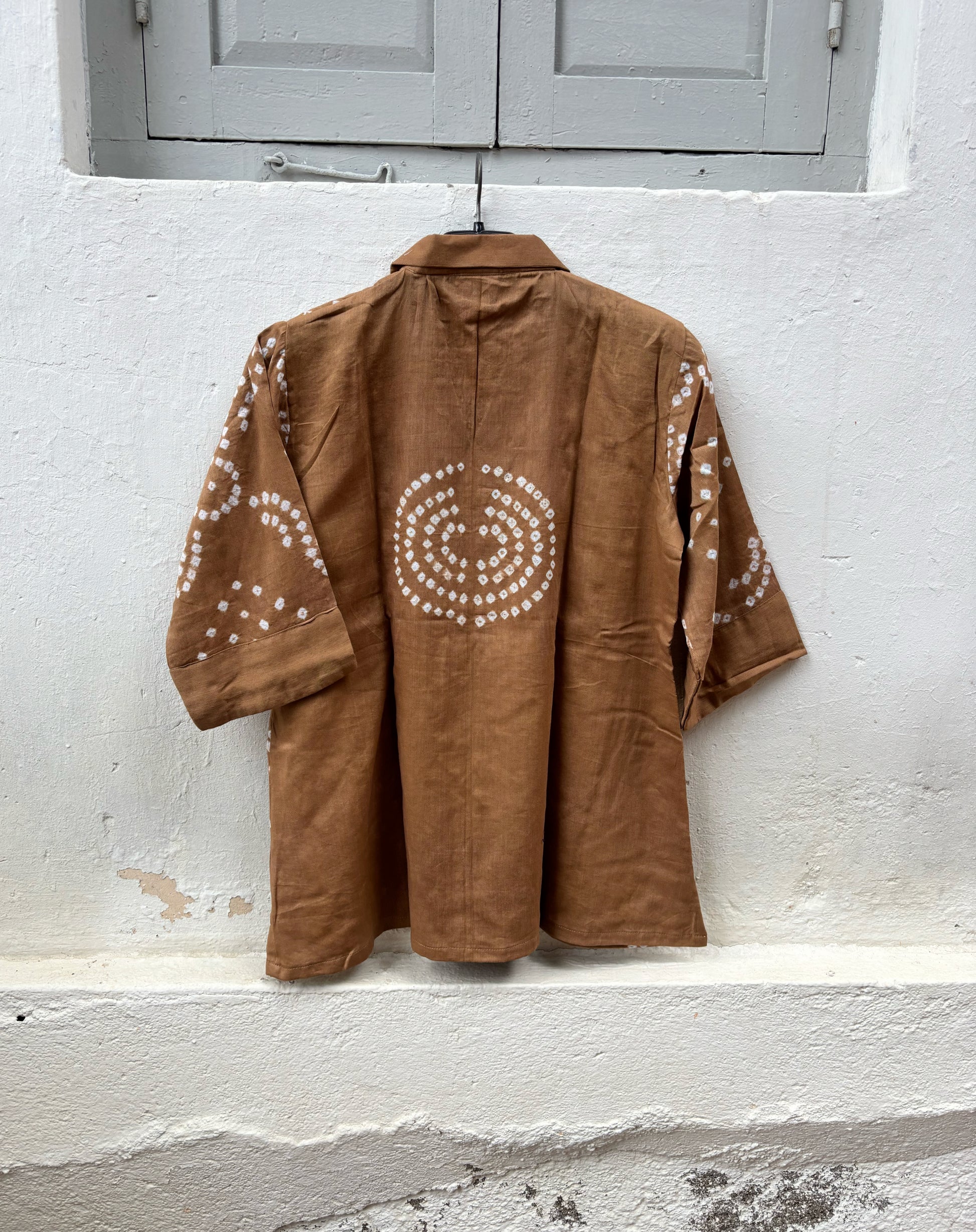 Back view of Toffee Brown Cotton Satin Bandhani Shirt featuring a circular Bandhani motif and handcrafted geometric tie-dyed details.