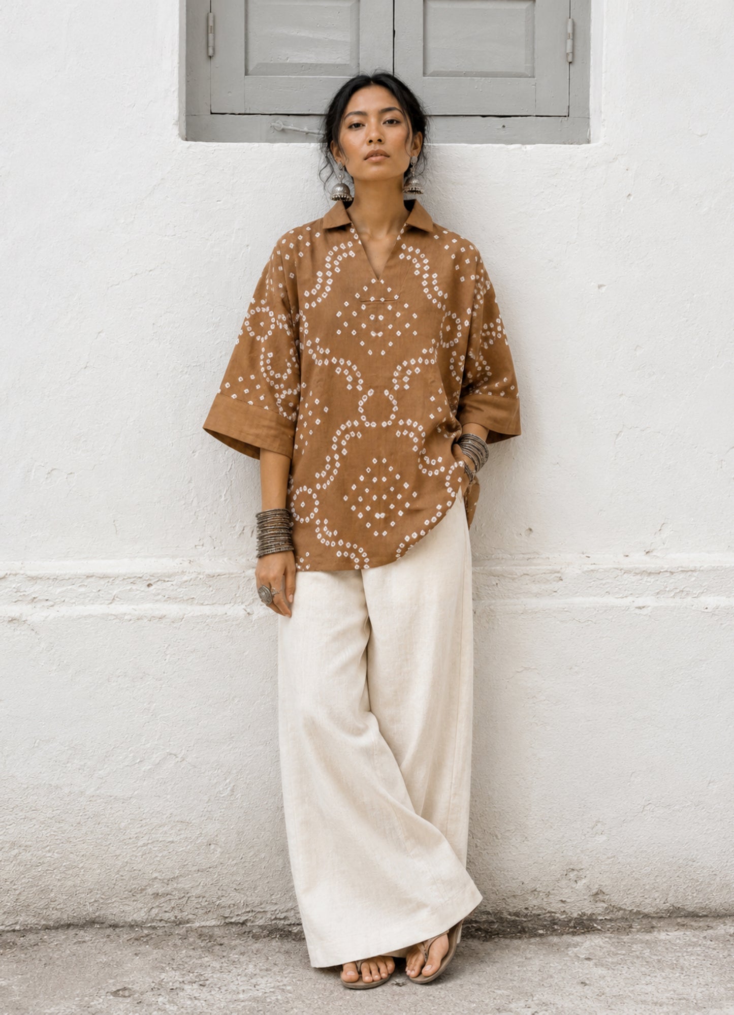 Toffee Brown Cotton Satin Bandhani Shirt with geometric hand tie-dyed motifs, open notch collar, V-neckline, relaxed fit, and elbow-length sleeves.