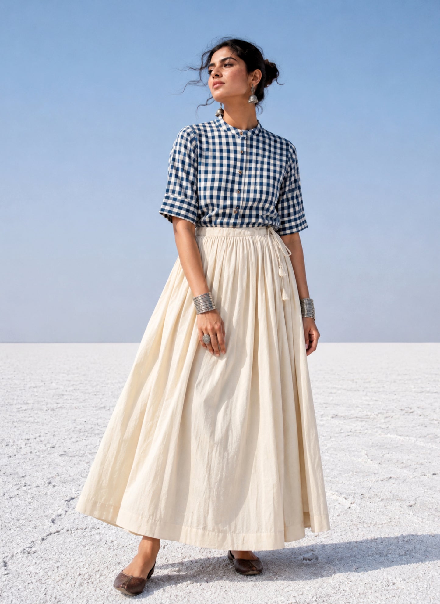Undyed raw hand-spun and handwoven cotton gathered skirt in natural off-white with adjustable tie strings, side zipper and flowing silhouette.
