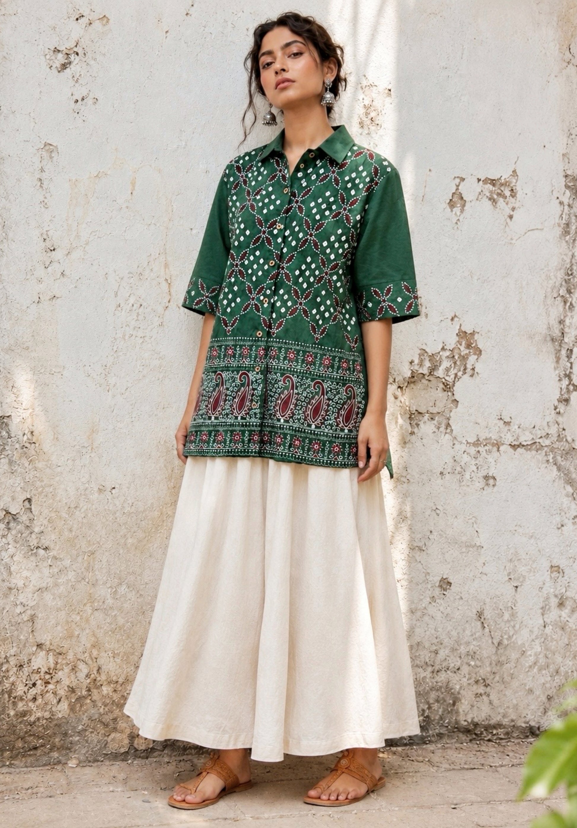 Forest green cotton satin Bandhani shirt with intricate machine embroidery, paisley border detailing, classic shirt collar and relaxed fit silhouette.