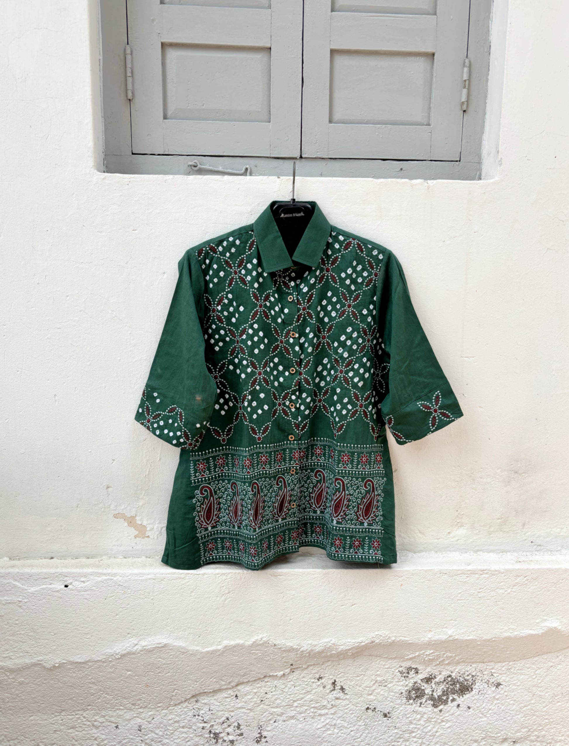 Forest green cotton satin Bandhani shirt with intricate machine embroidery, paisley border detailing, classic shirt collar and relaxed fit silhouette.