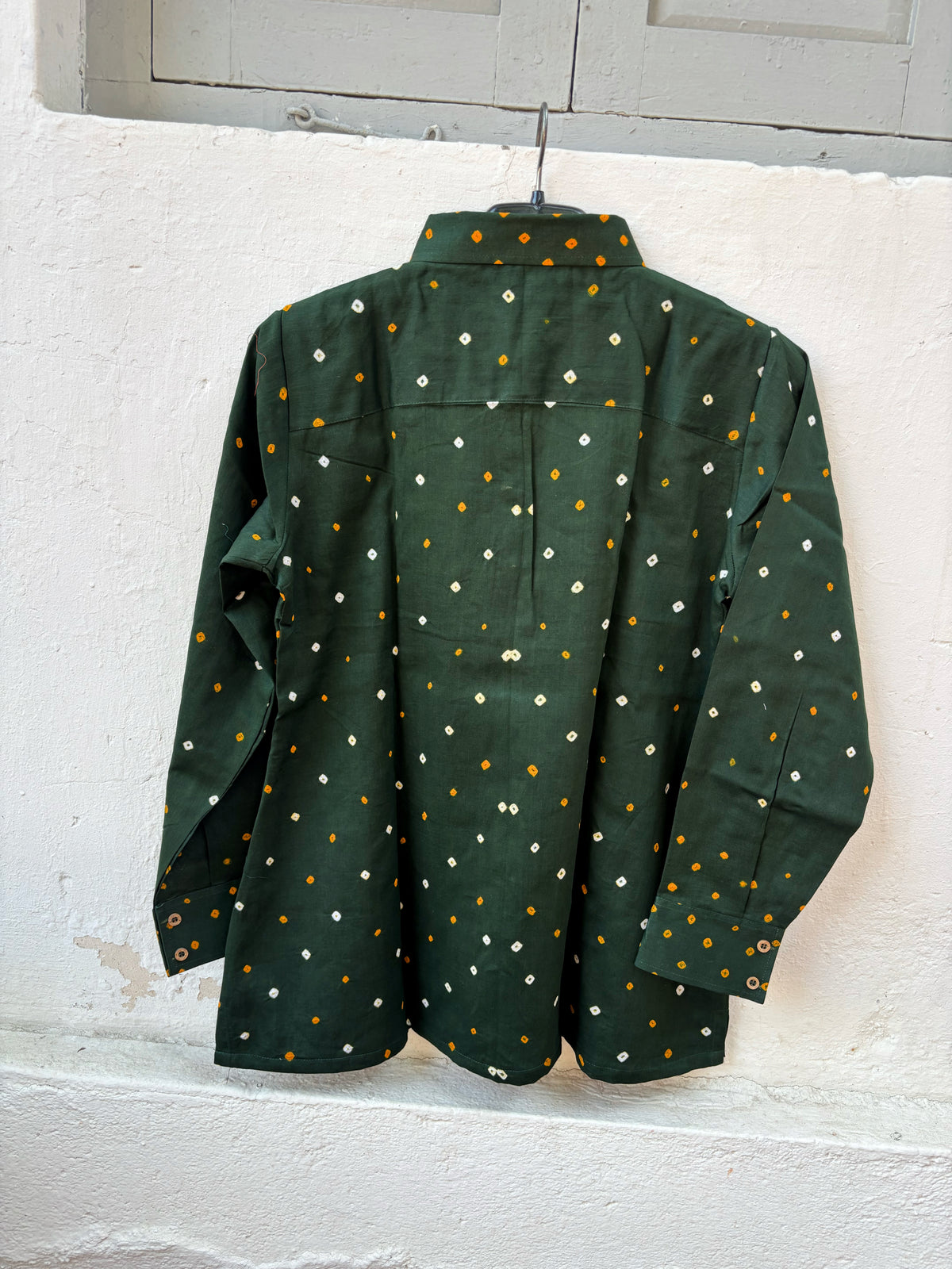 Vanrai deep green cotton shirt with turmeric-yellow Bandhani dots and off-white floral motifs on the front