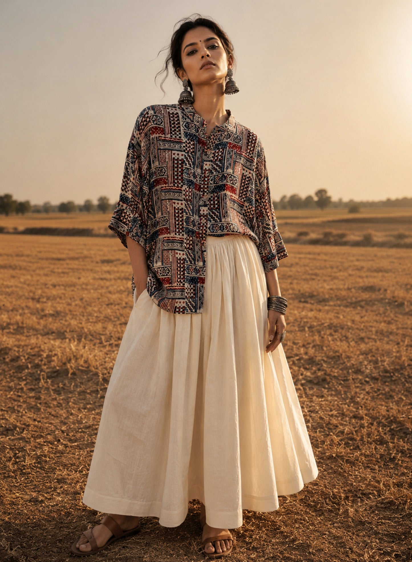 Natural dyed Ajrakh hand block printed modal silk oversized shirt for women in myrobalan beige with indigo blue and madder red geometric motifs.