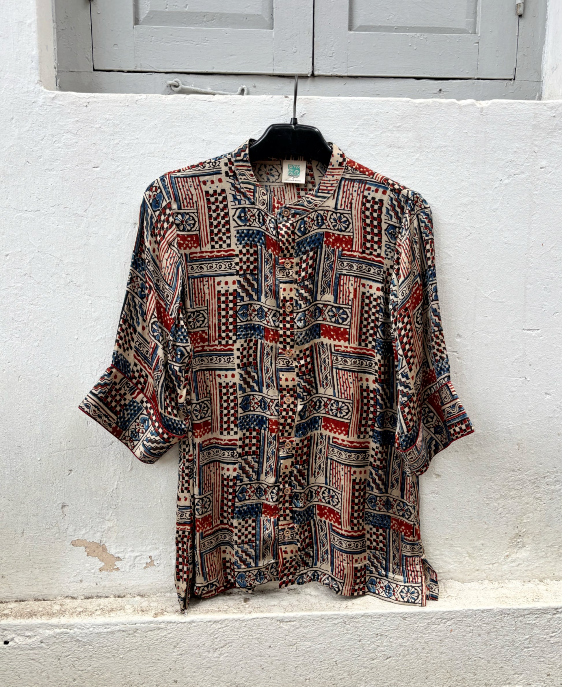 Natural dyed Ajrakh hand block printed modal silk oversized shirt for women in myrobalan beige with indigo blue and madder red geometric motifs.
