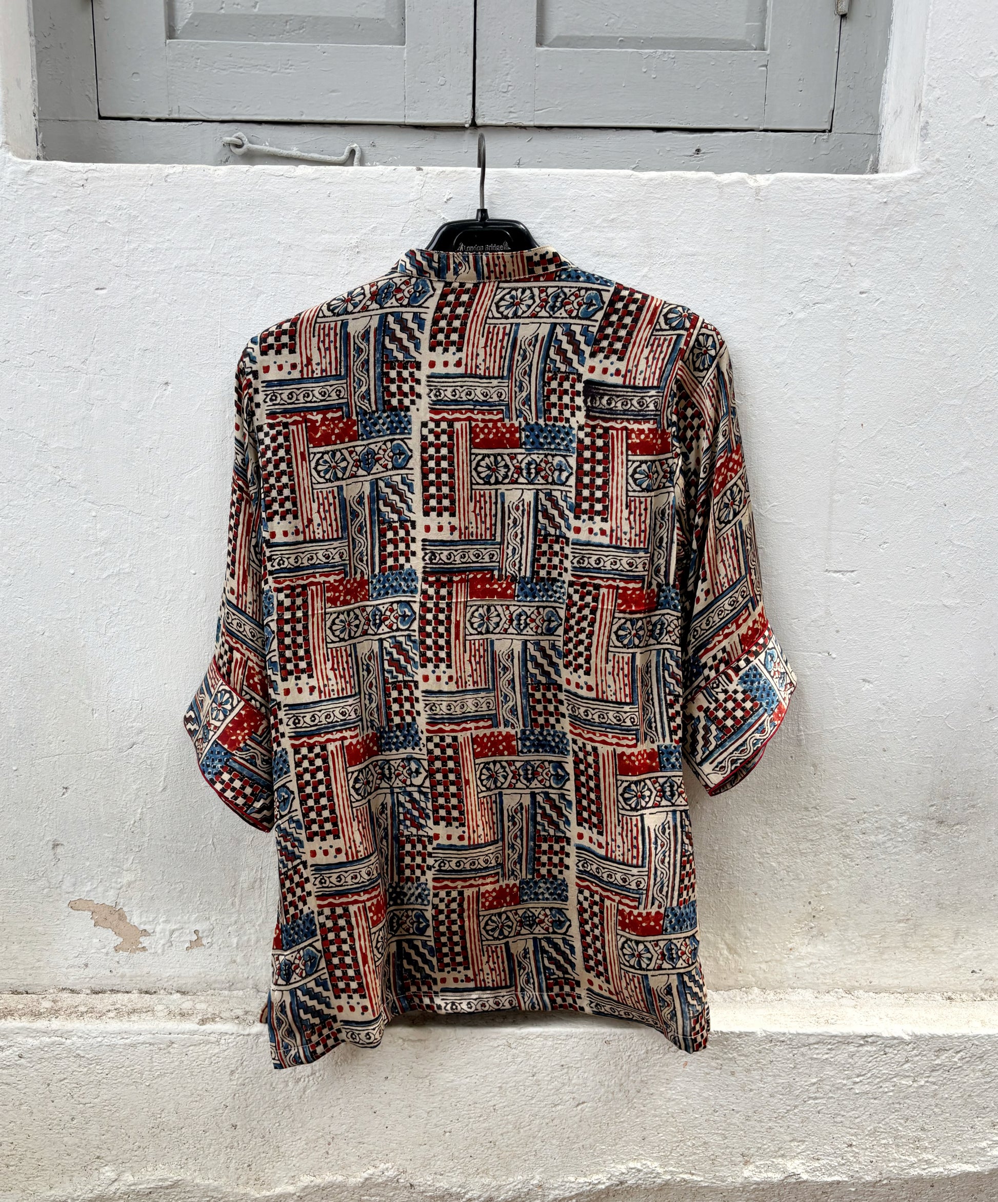 Natural dyed Ajrakh hand block printed modal silk oversized shirt for women in myrobalan beige with indigo blue and madder red geometric motifs.