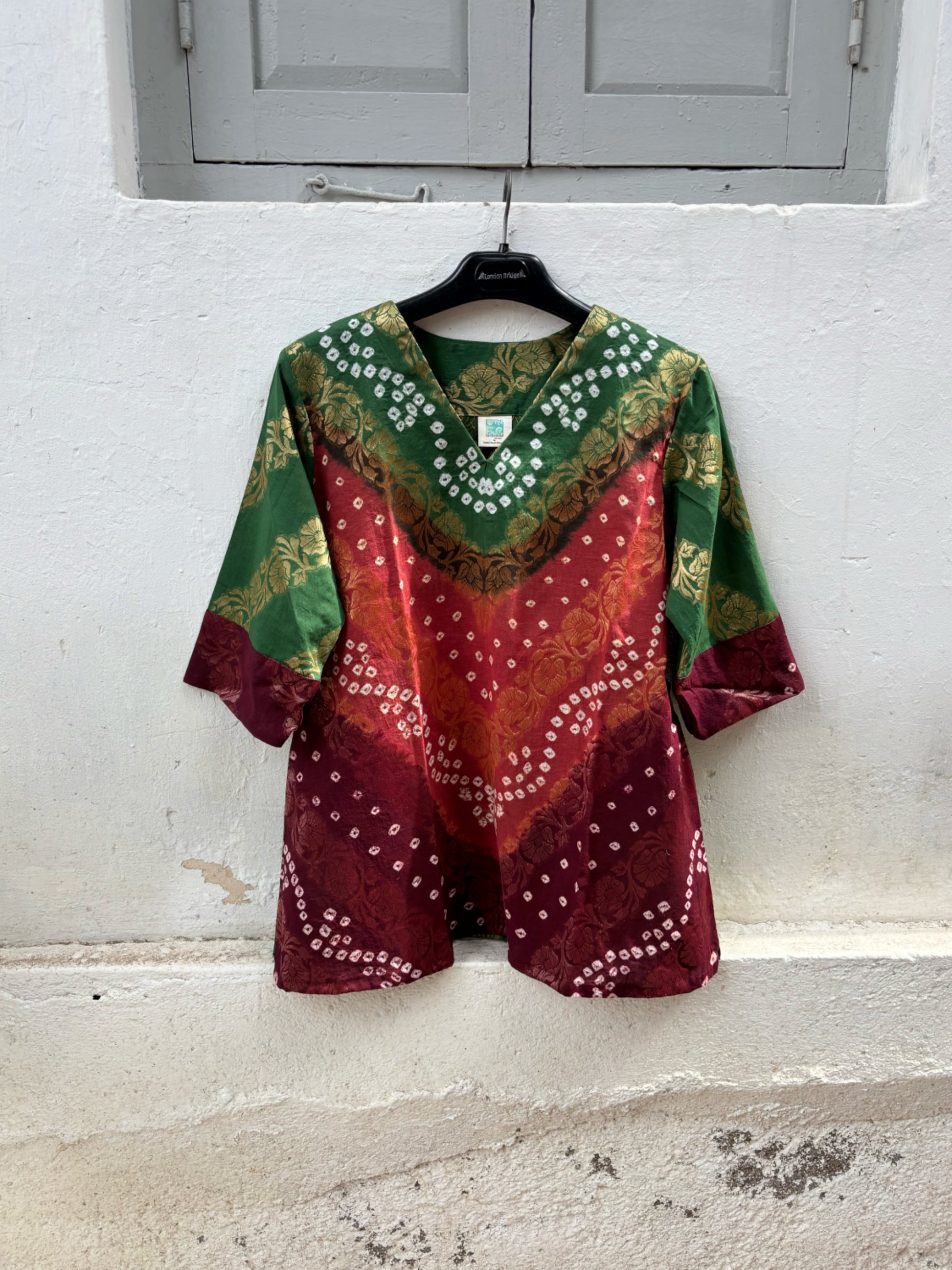 Handcrafted Bandhani festive cotton top in Forest Green, Rust Ochre and Wine Maroon with antique gold woven floral motifs, V-neck, relaxed fit and three-quarter sleeves.