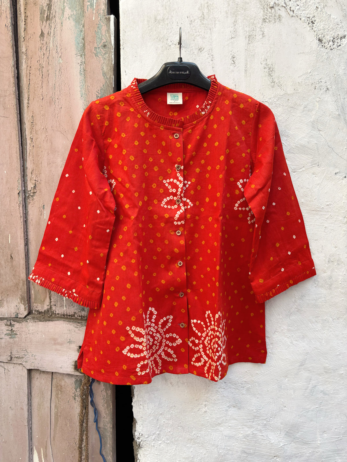 Vermilion orange cotton shirt with hand tie-dyed Bandhani, pleated neckline and three-quarter sleeves