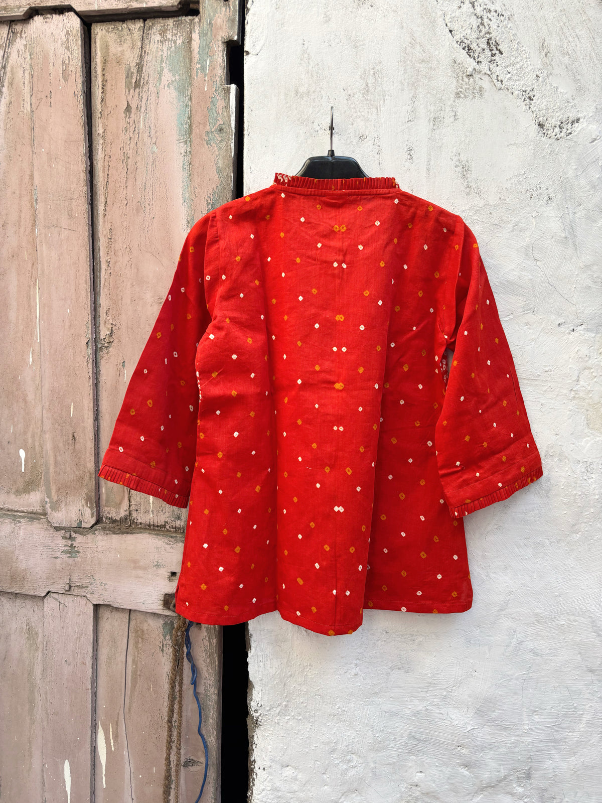 Vermilion orange cotton shirt with hand tie-dyed Bandhani, pleated neckline and three-quarter sleeves