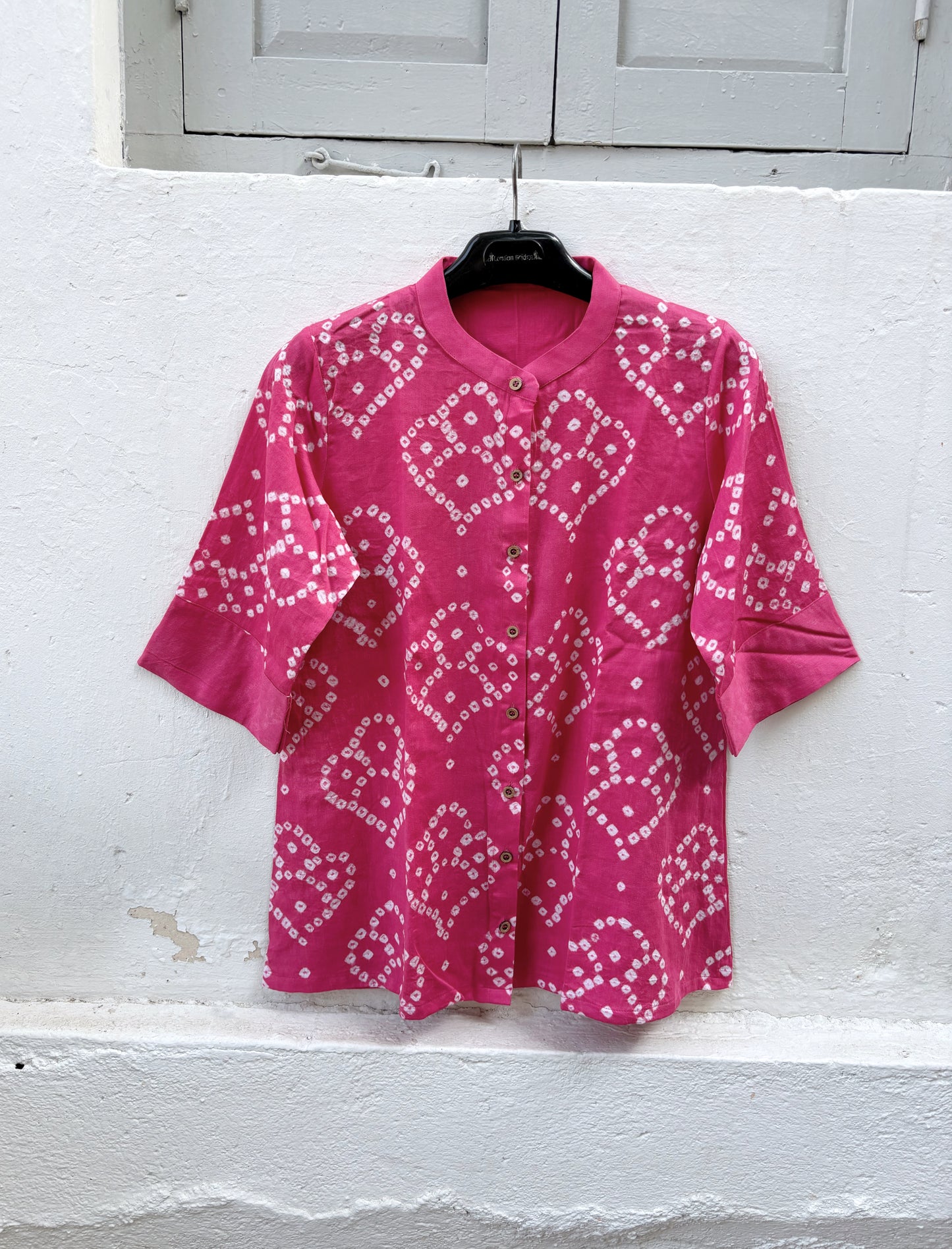 Hand tie-dyed Bandhani cotton satin shirt in Wild Rose Pink with white handcrafted Bandhani motifs, soft mandarin collar and relaxed fit.