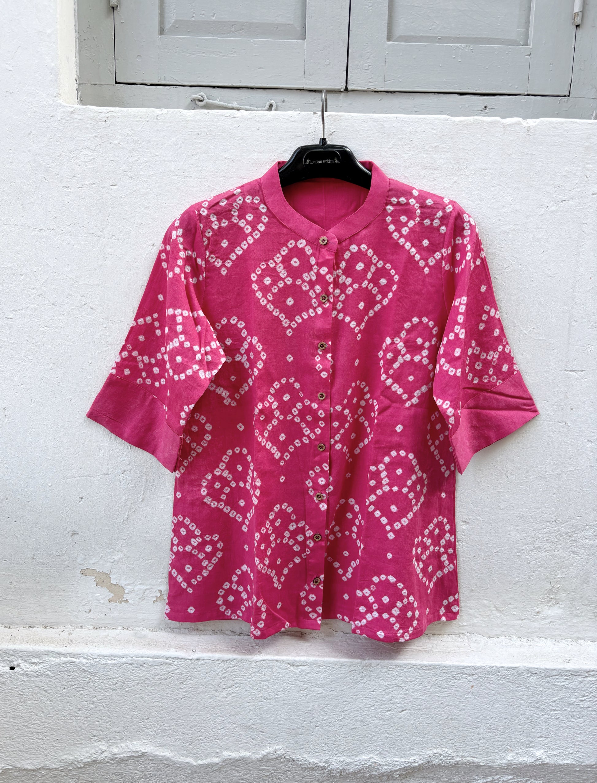 Hand tie-dyed Bandhani cotton satin shirt in Wild Rose Pink with white handcrafted Bandhani motifs, soft mandarin collar and relaxed fit.
