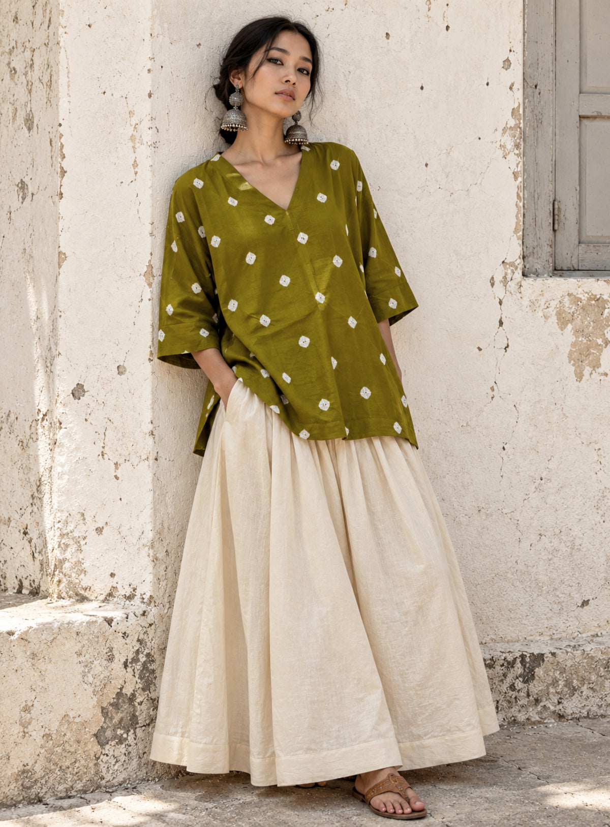 Zaitoon olive green cotton satin top with ivory hand tie-dyed Bandhani motifs, V-neckline and wide three-quarter sleeves.